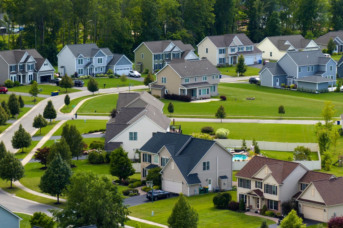 Low-density private homes on green lawns in a rural residential suburb