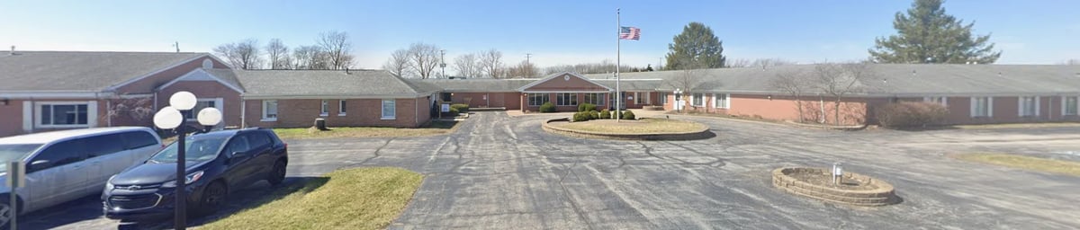 Richland Place Veterans Housing — one-story brick building with American flag in front and surrounding grounds
